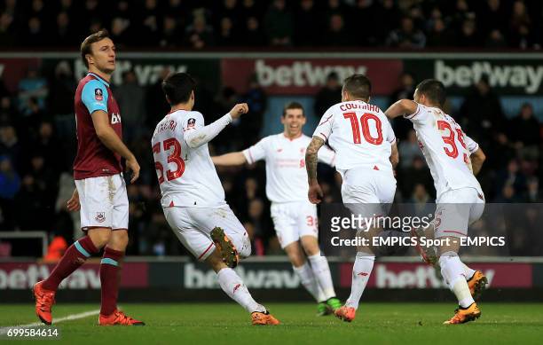 Liverpool's Philippe Coutinho celebrates scoring his side's first goa as West Ham United's Mark Noble looks on during the Emirates FA Cup, fourth...