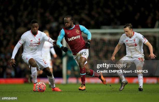 West Ham United's Victor Moses in action with Liverpool's Divock Origi and Brad Smith during the Emirates FA Cup, fourth round replay match at Upton...