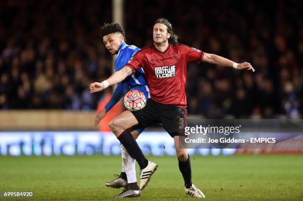 Peterborough United's Lee Angol and West Bromwich Albion's Jonas Olsson battle for the ball