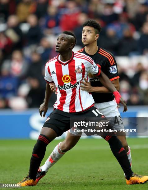 Sunderland's Dame N'Doye and Manchester United's Cameron Borthwick-Jackson battle for the ball