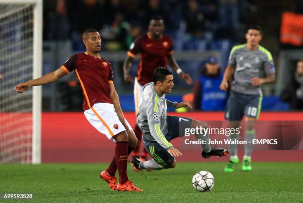 Real Madrid's Cristiano Ronaldo, is sent flying under the challenge of Roma's Diego Perotti,