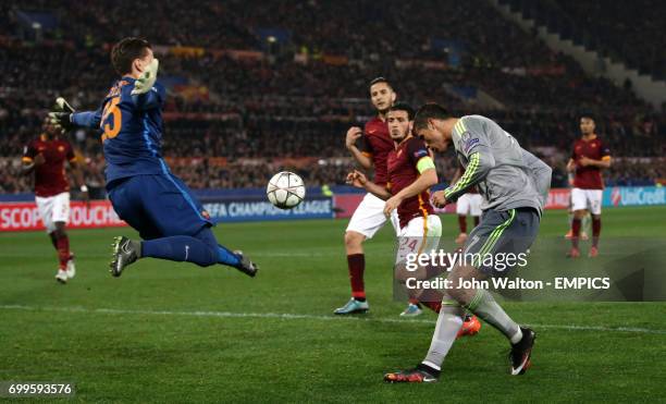 Real Madrid's Cristiano Ronaldo fails to score from his headed attempt on goal as Roma's goalkeeper Wojciech Szczesny comes out to block