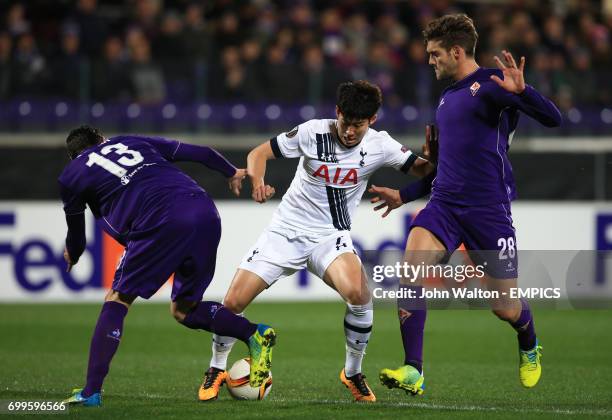 Fiorentina's Davide Astori Tottenham Hotspur's Son Heung-Min and Fiorentina's Marcos Alonso battle for the ball