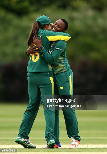 Masabata Klaas of South Africa celebrates a wicket with team mate Sune Luus during the ICC Women's World Cup warm up match between West Indies and...