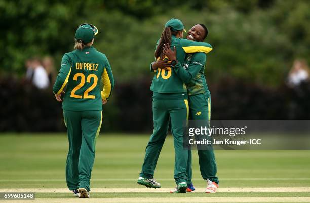 Masabata Klaas of South Africa celebrates a wicket with team mate Sune Luus during the ICC Women's World Cup warm up match between West Indies and...
