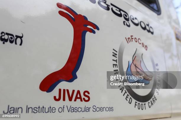 The logo for the Jain Institute of Vascular Sciences is displayed on the exterior of a vehicle in Bengaluru, India, on Friday, June 9, 2017. Millets...