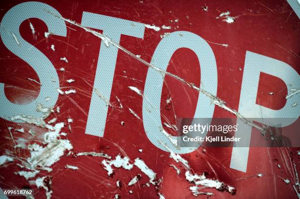 stop sign with scratches - red light stock-fotos und bilder