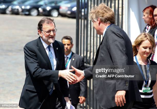 Spanish Prime Minister Mariano Rajoy shakes hands as he arrives at the European People's Party headquarters in Brussels for a EPP meeting on the...