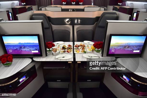 This picture shows the 'QSuite' business class of a Qatar Airways Boeing 777 jet airliner on display at the International Paris Air Show in Le...