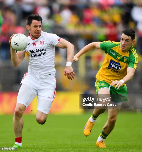 Monaghan , Ireland - 18 June 2017; Mattie Donnelly of Tyrone in action against Eoin McHugh of Donegal during the Ulster GAA Football Senior...