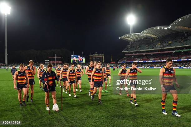 The Crows players walk from the field after the round 14 AFL match between the Adelaide Crows and the Hawthorn Hawks at Adelaide Oval on June 22,...