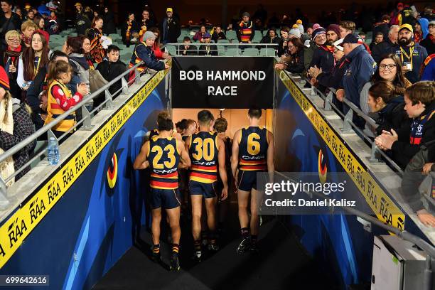 The Crows players walk from the field after the round 14 AFL match between the Adelaide Crows and the Hawthorn Hawks at Adelaide Oval on June 22,...