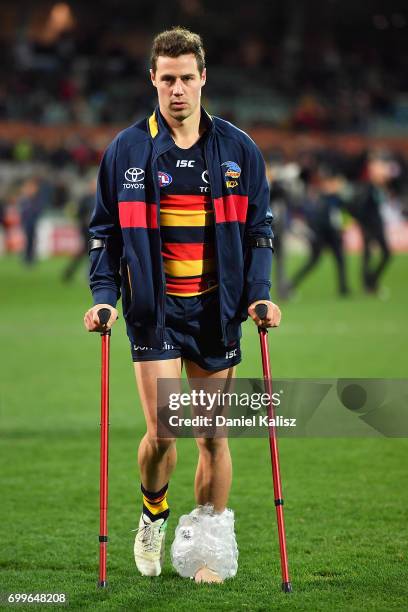 Luke Brown of the Crows walks from the field injured after the round 14 AFL match between the Adelaide Crows and the Hawthorn Hawks at Adelaide Oval...