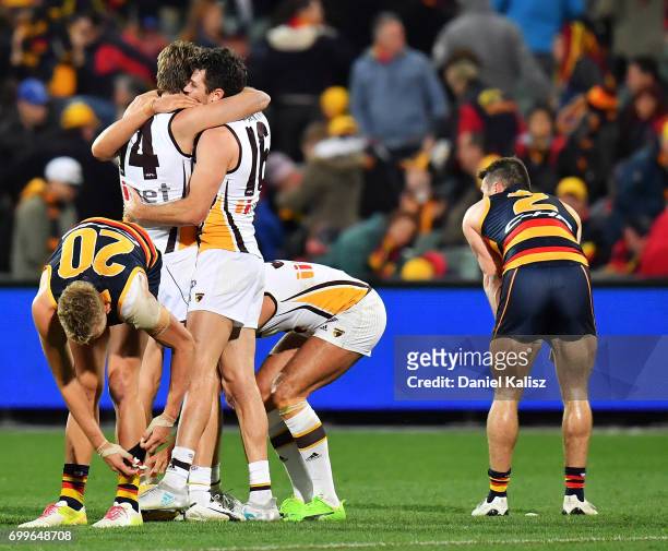 Grant Birchall and Isaac Smith of the Hawks celebratre after the final siren during the round 14 AFL match between the Adelaide Crows and the...