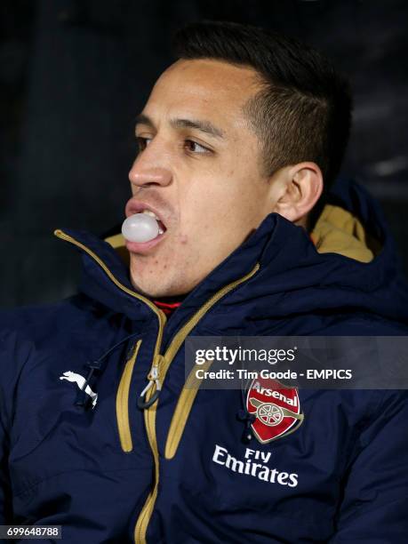 Arsenal's Alexis Sanchez sits on the bench