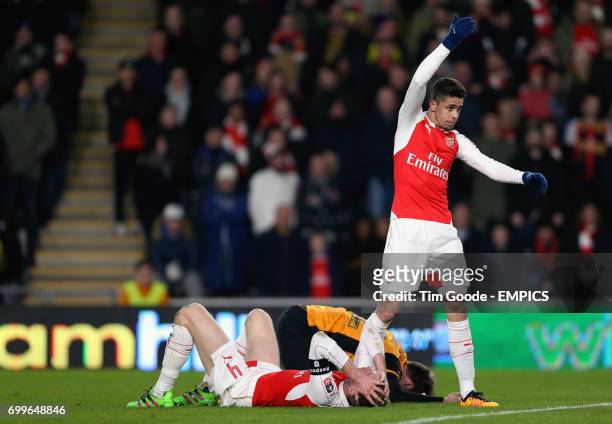 Arsenal's Gabriel Paulista reacts as Arsenal's Per Mertesacker collides with Hull City's Nick Powell
