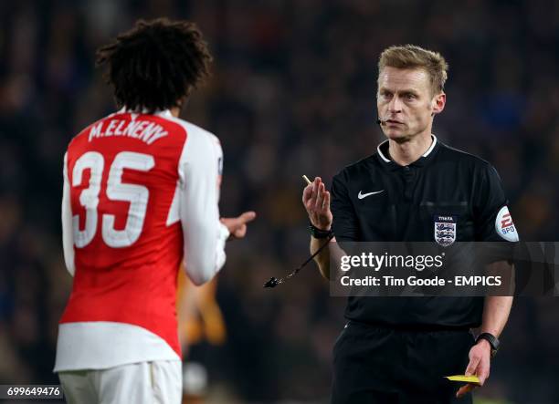 Arsenal's Mohamed Elneny appeals after a booking from match referee Mike Jones