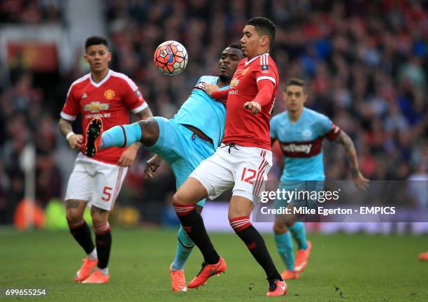 Manchester United's Chris Smalling and West Ham United's Emmanuel Emenike battle for the ball