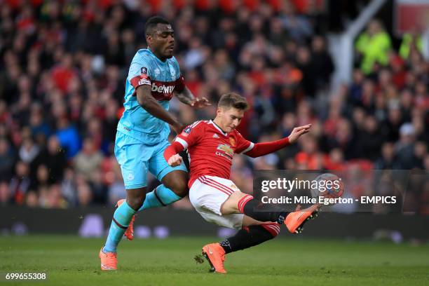Manchester United's Gullermo Varela and West Ham United's Emmanuel Emenike battle for the ball