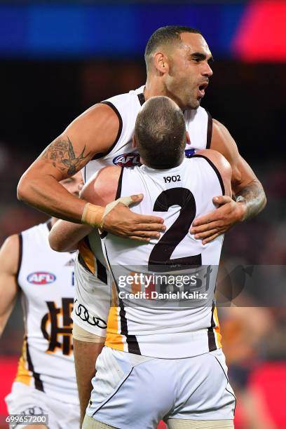 Shaun Burgoyne celebrates with Jarryd Roughead of the Hawks after kicking a goal during the round 14 AFL match between the Adelaide Crows and the...