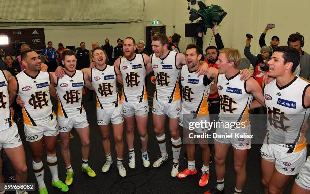 Hawthorn players sing the club song after the round 14 AFL match between the Adelaide Crows and the Hawthorn Hawks at Adelaide Oval on June 22, 2017...