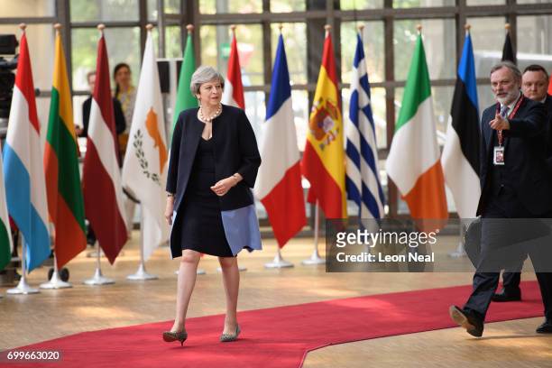 British Prime Minister Theresa May and the EU Ambassador for the UK Tim Barrow arrive at the EU Council headquarters ahead of a European Council...