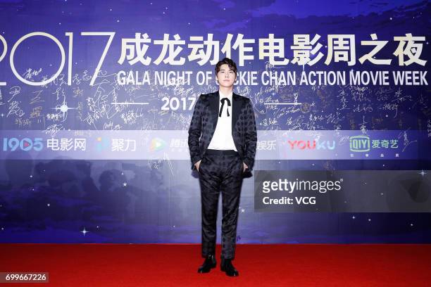Actor Li Yifeng arrives at the red carpet of Gala Night of Jackie Chan Action Movie Week during the 20th Shanghai International Film Festival on June...