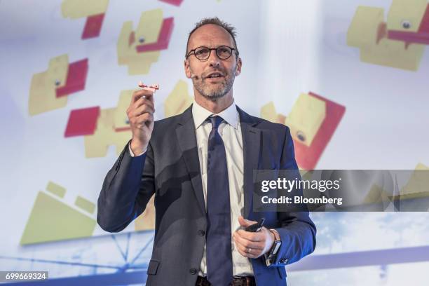 Jorgen Vig Knudstorp, chief executive officer of Lego A/S, holds up a Lego brick as he speaks during a panel session at the 61st Global Summit of the...