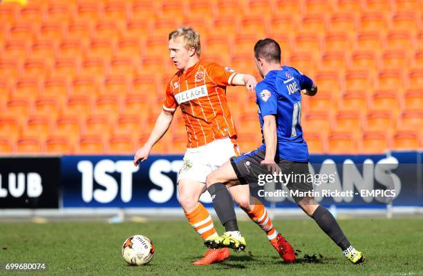 Blackpool's Mark Cullen battles for the ball with Bury's Craig Jones