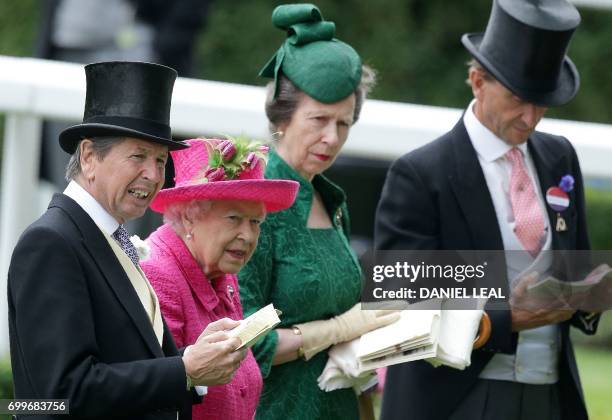 Britain's Queen Elizabeth II talks with the Queen's Bloodstock and Racing Advisor, John Warren and her daughter Britain's Princess Anne, Princess...