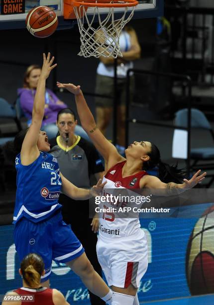 Saziye Ivegin Uner of Turkey tries to block Eleanna Christinaki of Greece during the FIBA EuroBasket women's quarterfinal match between Turkey v...