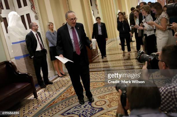 Senate Minority Leader Chuck Schumer talks with reporters outside the room where Republican members of the Senate were meeting on their proposed...