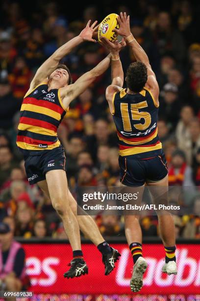 Jake Kelly and Kyle Hartigan of the Crows fly during the 2017 AFL round 14 match between the Adelaide Crows and the Hawthorn Hawks at the Adelaide...