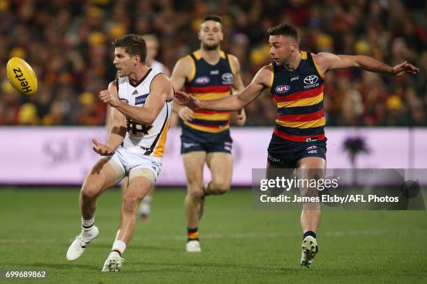 Luke Breust of the Hawks is tackled by Rory Atkins of the Crows during the 2017 AFL round 14 match between the Adelaide Crows and the Hawthorn Hawks...