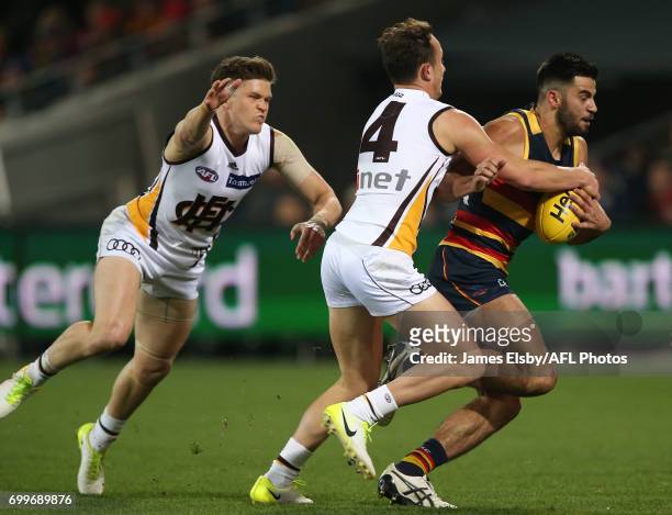 Billy Hartung of the Hawks tackles Wayne Milera of the Crows during the 2017 AFL round 14 match between the Adelaide Crows and the Hawthorn Hawks at...