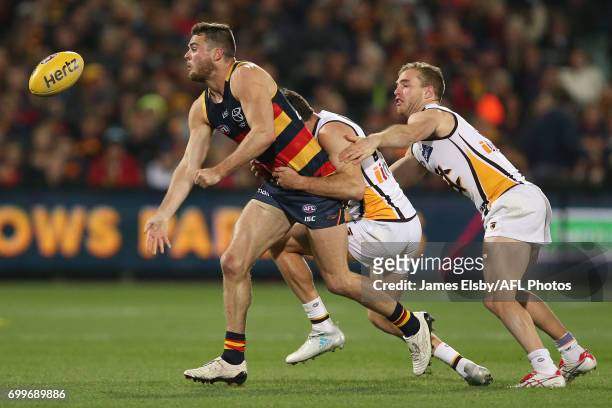 Brad Crouch of the Crows tackled by Isaac Smith of the Hawks during the 2017 AFL round 14 match between the Adelaide Crows and the Hawthorn Hawks at...
