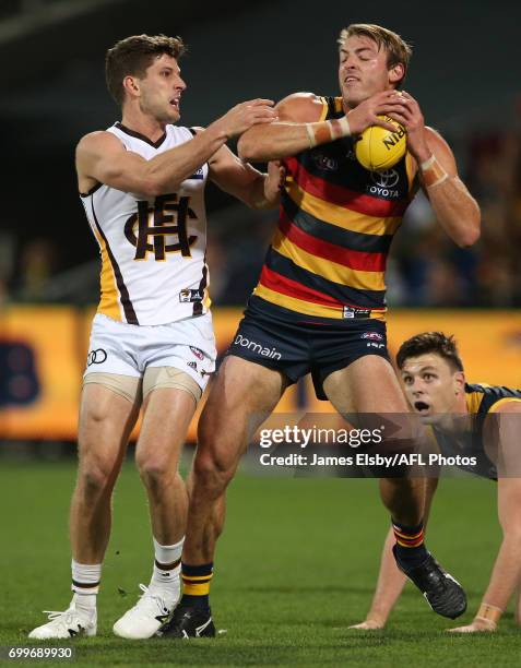 Luke Breust of the Hawks tackles Daniel Talia of the Crows during the 2017 AFL round 14 match between the Adelaide Crows and the Hawthorn Hawks at...