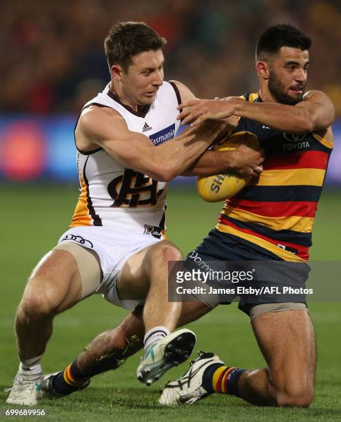 Liam Shiels of the Hawks tackles Wayne Milera of the Crows during the 2017 AFL round 14 match between the Adelaide Crows and the Hawthorn Hawks at...