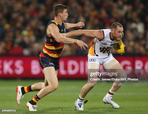 Josh Jenkins of the Crows tackles Jarryd Roughead of the Hawks during the 2017 AFL round 14 match between the Adelaide Crows and the Hawthorn Hawks...