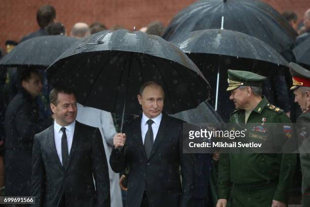 Russian President Vladimir Putin , Defence Minister Sergei Shoigu and Prime Minister Dmitry Medvedev attend the wreath laying ceremony at the Unknown...