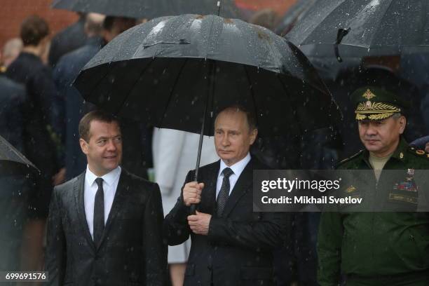 Russian President Vladimir Putin , Defence Minister Sergei Shoigu and Prime Minister Dmitry Medvedev attend the wreath laying ceremony at the Unknown...