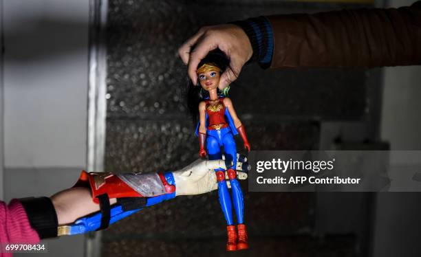 Colombian Shaio Valeria Novas tries her 3D printed prosthesis with a superhero "Wonder Woman" design, in Bogota, Colombia on June 12, 2017. Fabrilab...