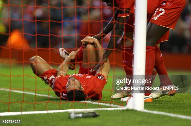 Liverpool's Emre Can lies in pain after picking up an injury.