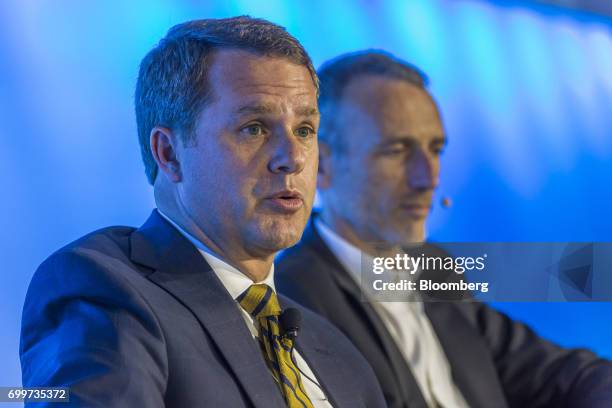 Doug McMillon, chief executive officer of Wal-Mart Stores Inc., left, speaks as Emmanuel Faber, chief executive officer of Danone SA, listens during...