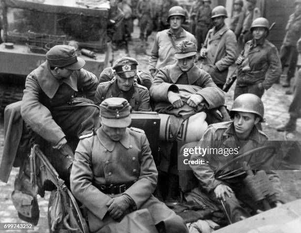 Picture released in 1944 of Colonel Wilk, commander of the German garrison at Aachen, riding in an American jeep with three of his staff officers...