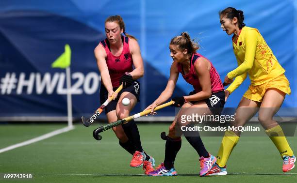 Yudiao Zhao of China battles with Alison Howie and Robyn Collins of Scotland during the FINTRO Women's Hockey World League Semi-Final Pool A game...