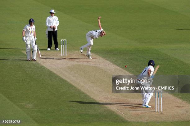 Surrey's Matt Dunn bowls to Durham's Ryan Pringle