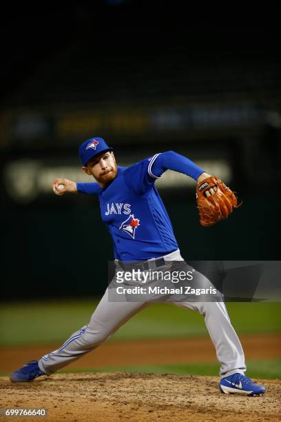 Danny Barnes of the Toronto Blue Jays pitches during the game against the Oakland Athletics at the Oakland Alameda Coliseum on June 5, 2017 in...