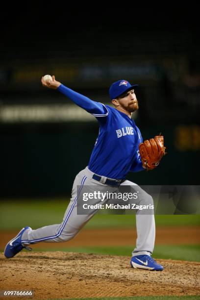 Danny Barnes of the Toronto Blue Jays pitches during the game against the Oakland Athletics at the Oakland Alameda Coliseum on June 5, 2017 in...