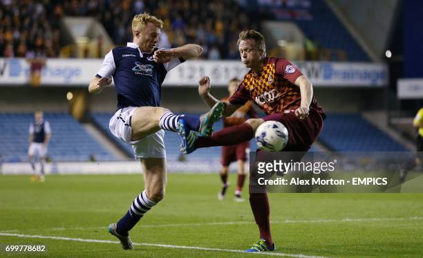 Millwall's Chris Taylor and Bradford City's Nathan Clarke battle for the ball
